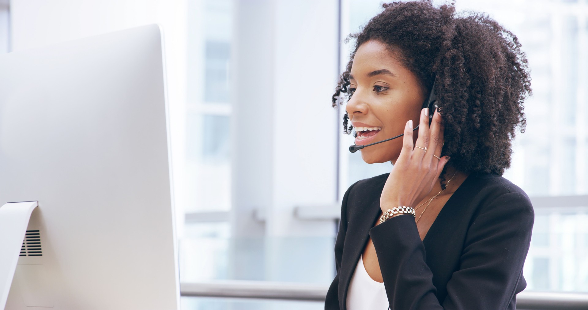 Happy woman, consultant or communication with headset at call center for online advice or help. Female person, agent or smile with mic for remote service, desktop support or friendly CRM at workplace