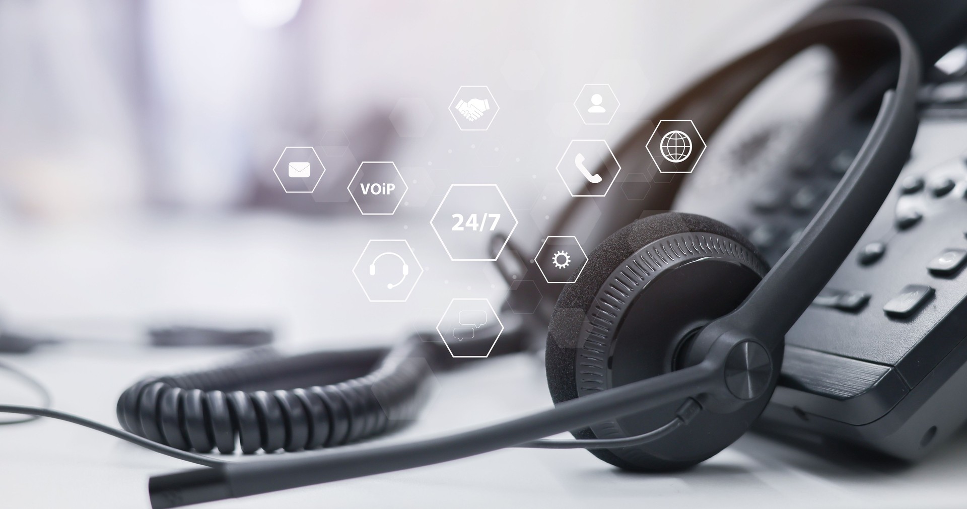 close up telephone voip machine with virtual icon of service provider of communication technology in the office desk operation station room for business and contact us concept